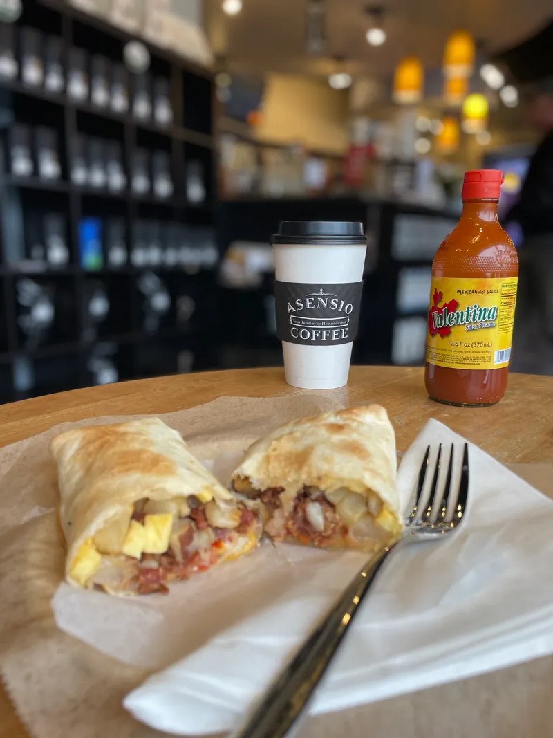 Honey Bee Latte in an Asensio Coffee branded cup