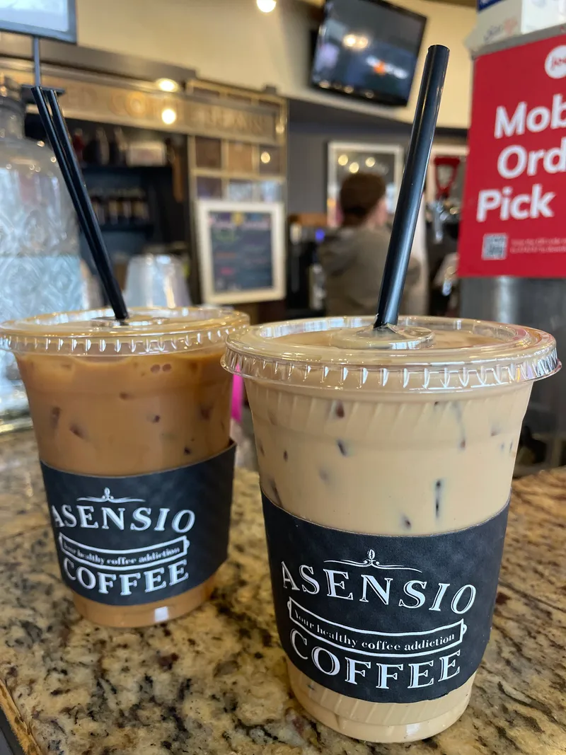 Branded cup with Asensio Coffee sleeve on the counter