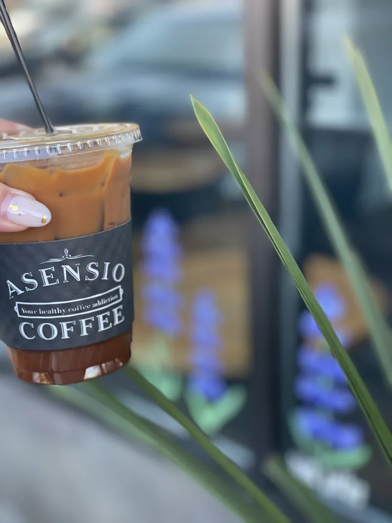Asensio Coffee cup next to the pastry display case