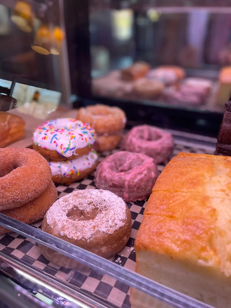 Donuts in the pastry case at Asensio Coffee